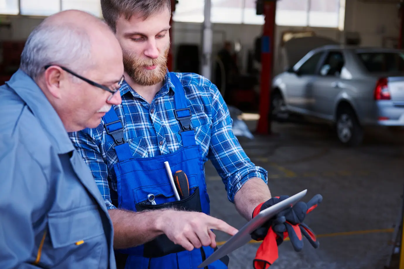 Field technicians using a tablet device to track parts delivery in real time for a repair job