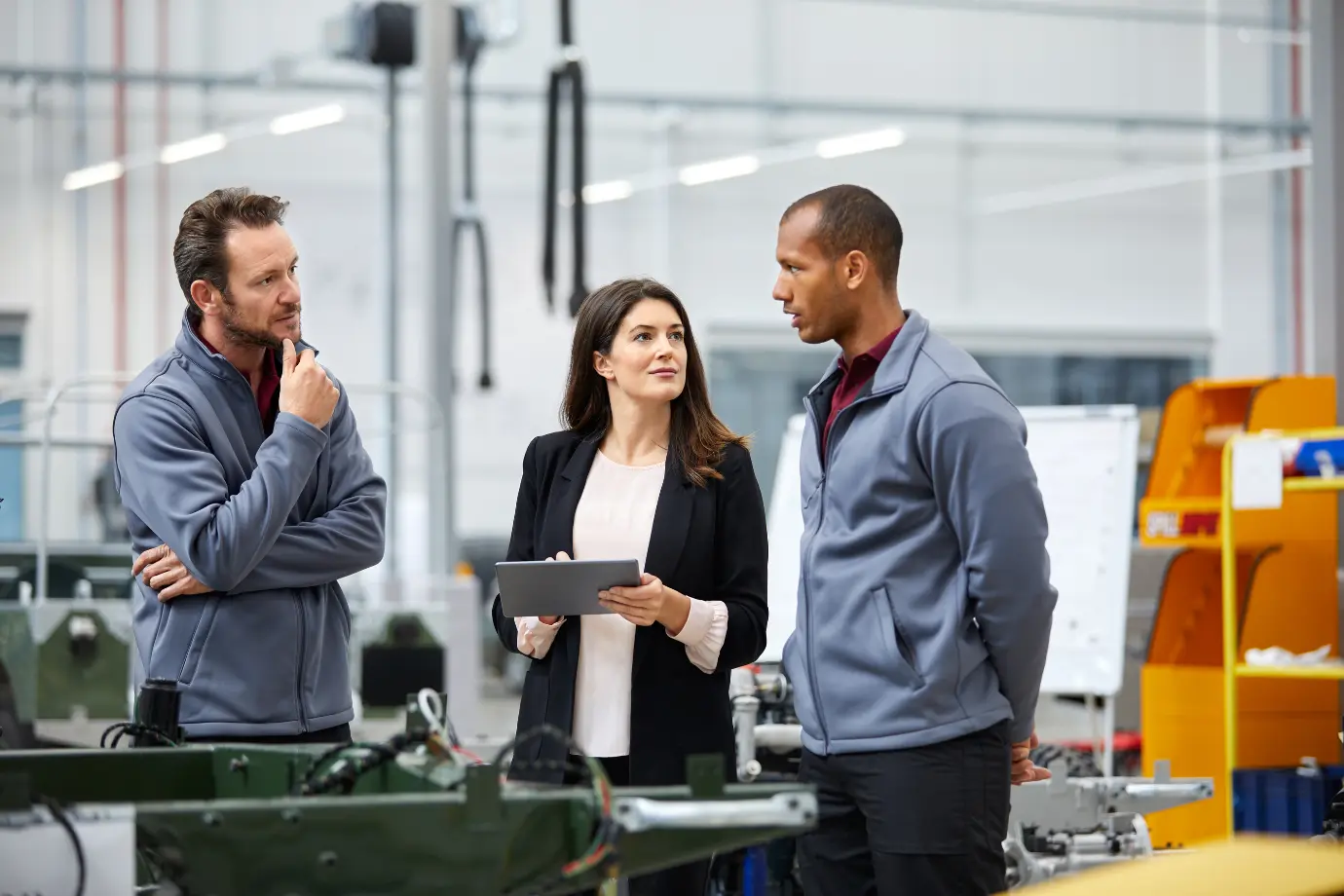 Automotive executives discussing SDV strategies in a meeting, symbolizing global competition