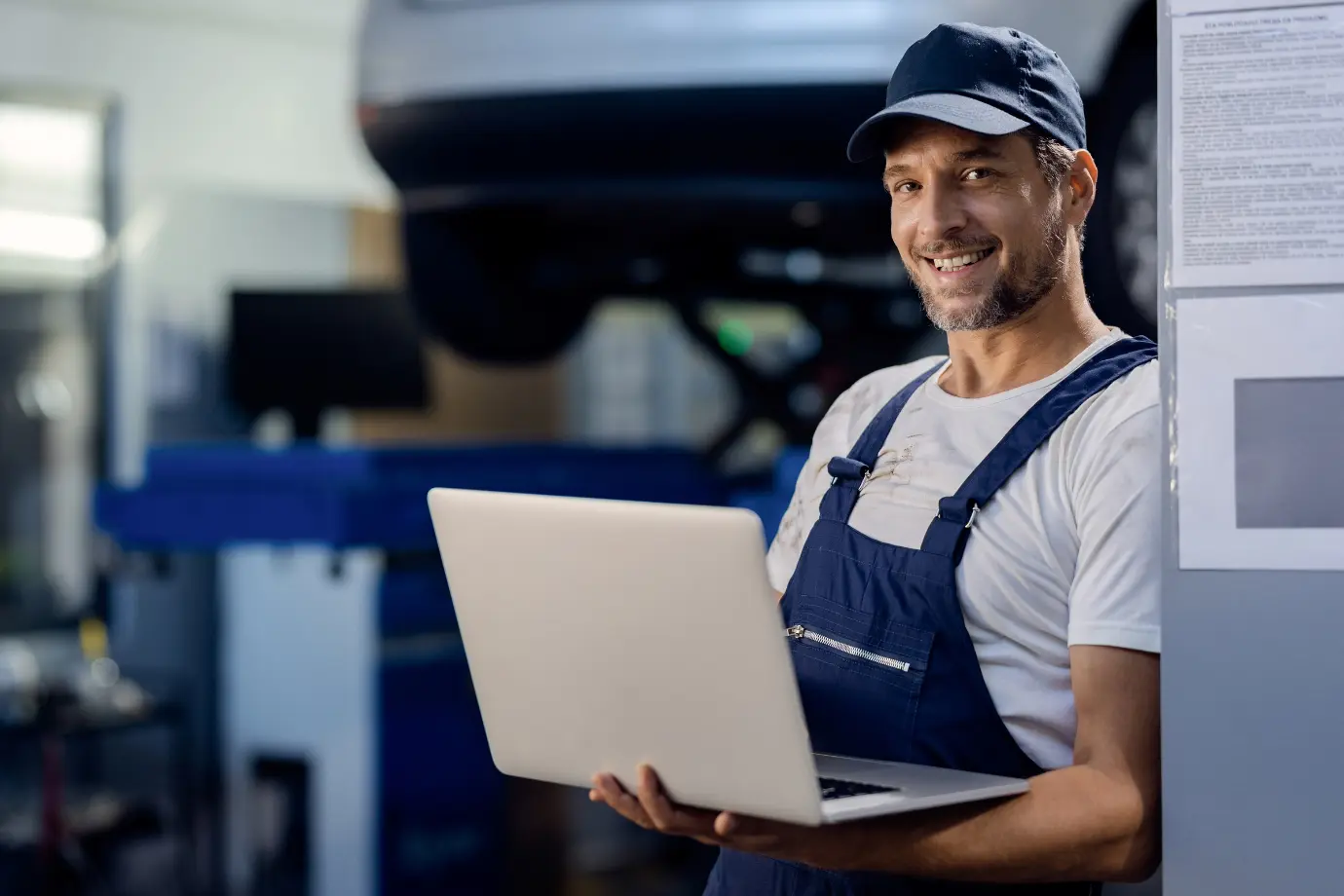 Technician using a laptop to enhance OEM aftermarket efficiency