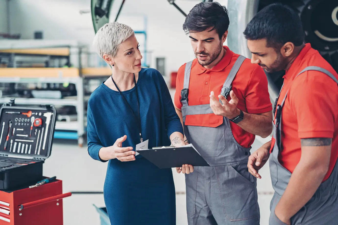 Technicians and a parts manager reviewing issues and planning improvements