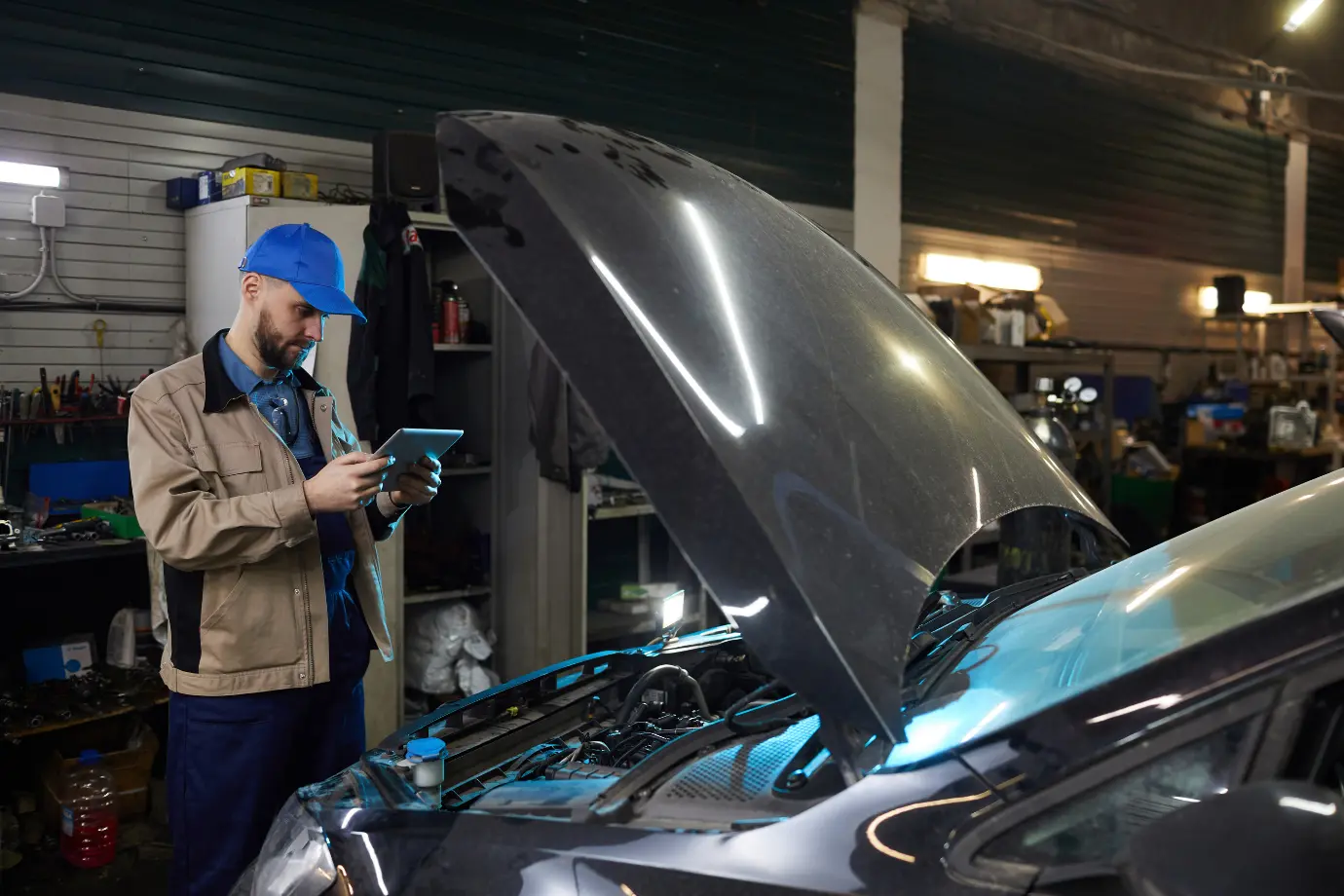 A technician searching for the right car parts in a cluttered catalog