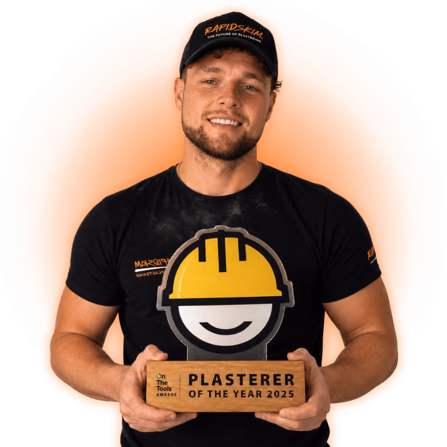 image of luke holding plasterer of the year award
