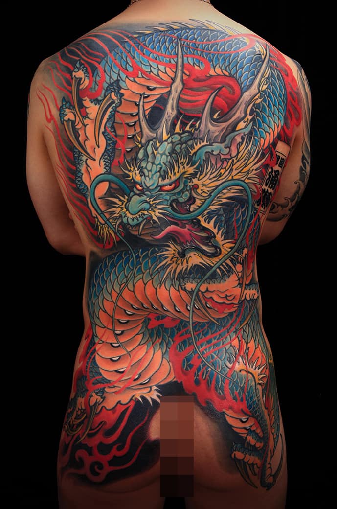 Traditional Japanese dragon back tattoo in blue and red