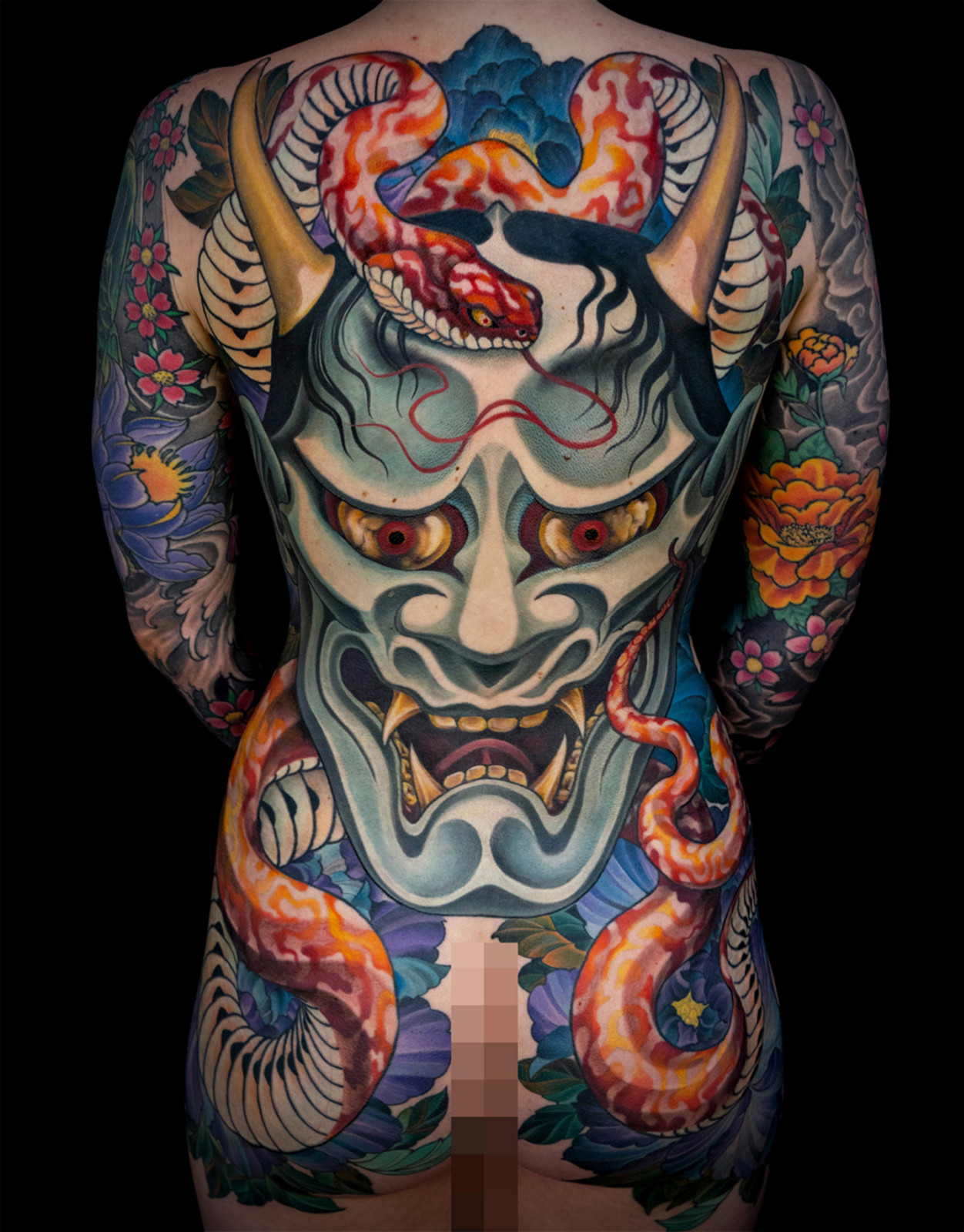Traditional Japanese oni mask back tattoo with blue demon face