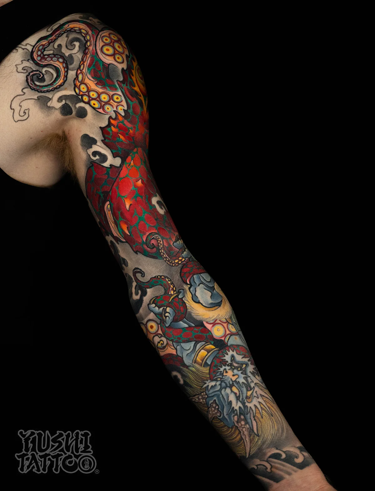 Color Japanese sleeve tattoo of a red octopus wrestling an Oni by Yushi, Oyabun Tattoo San Diego
