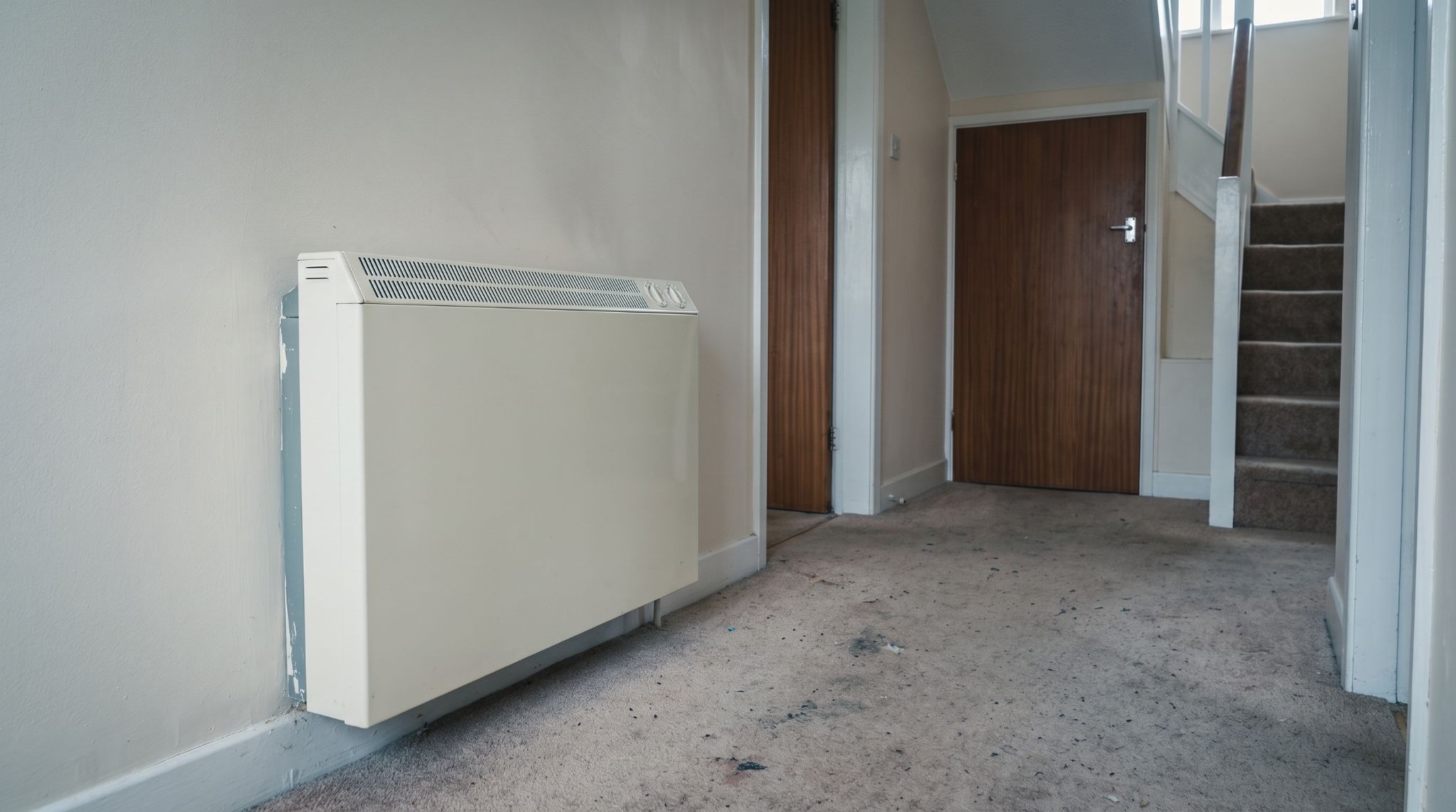 Electric storage heater in an Irish hallway, a heating system a smart thermostat cannot control