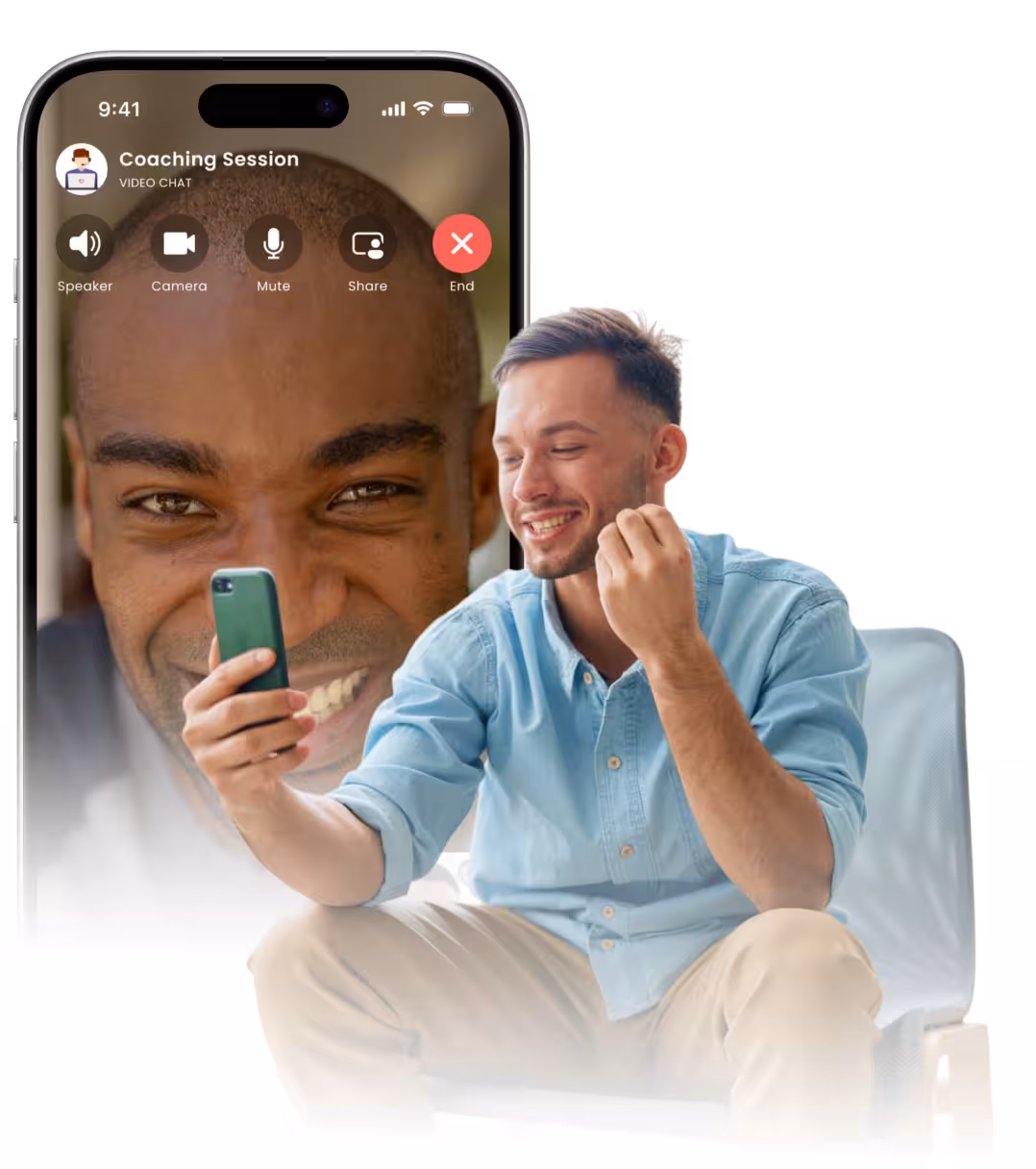 Smiling man in light blue shirt sitting and holding a phone for a video chat coaching session with a large face of another man on the phone screen.
