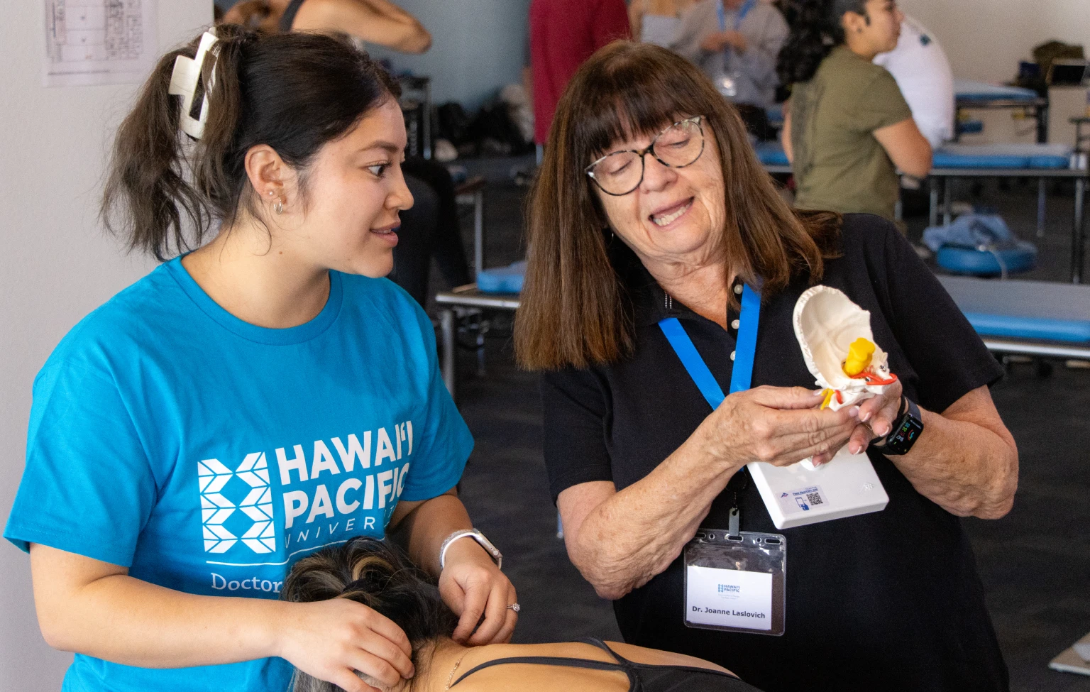 A faculty member explains a spinal model to a physical therapy student during hands-on instruction at Hawai‘i Pacific University.