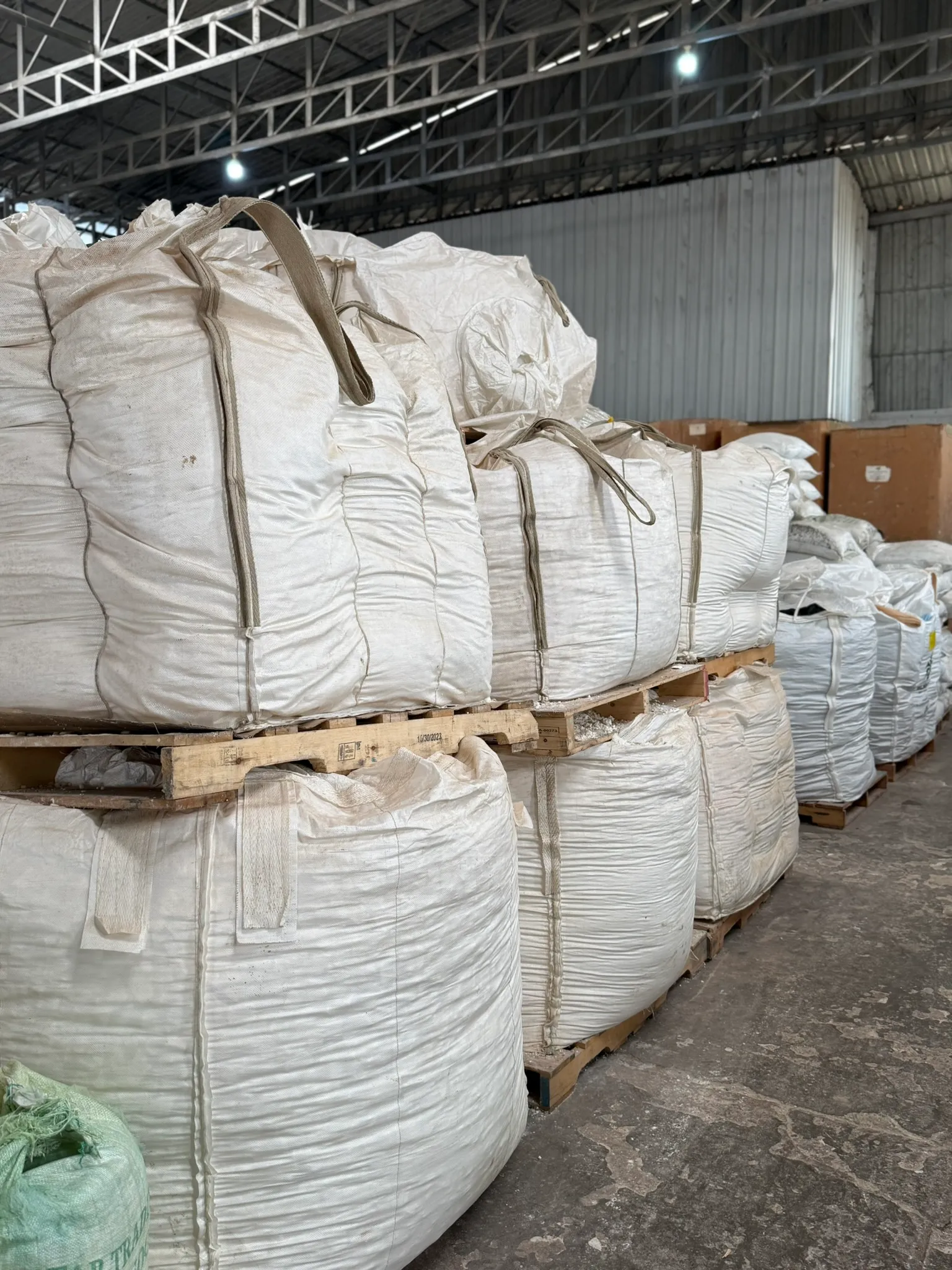 Pallets of bagged soap scrap collected from manufacturers in a warehouse