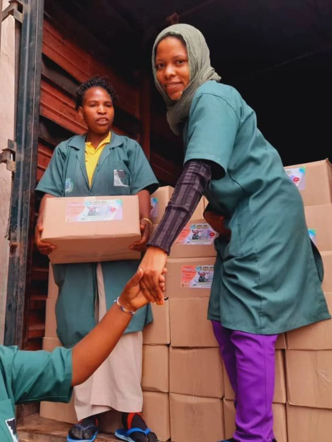 Hub team members unloading boxes of finished soap from a delivery truck