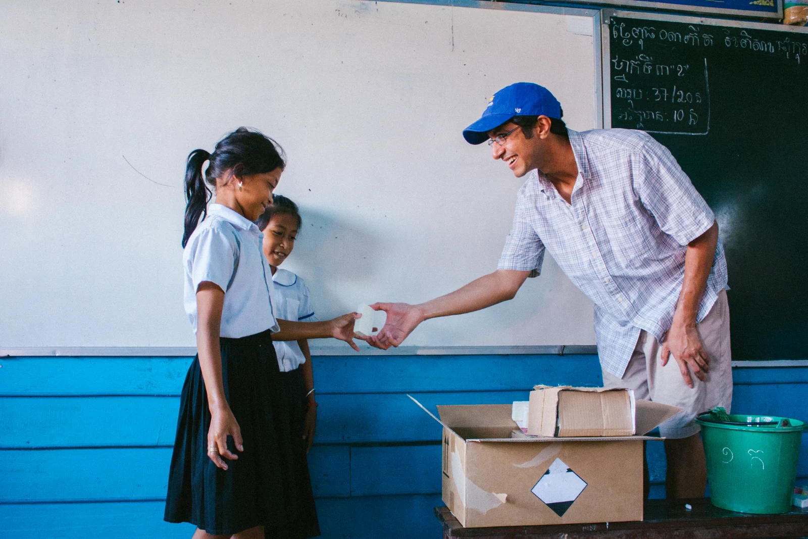 A student receiving a bar of upcycled soap at her school