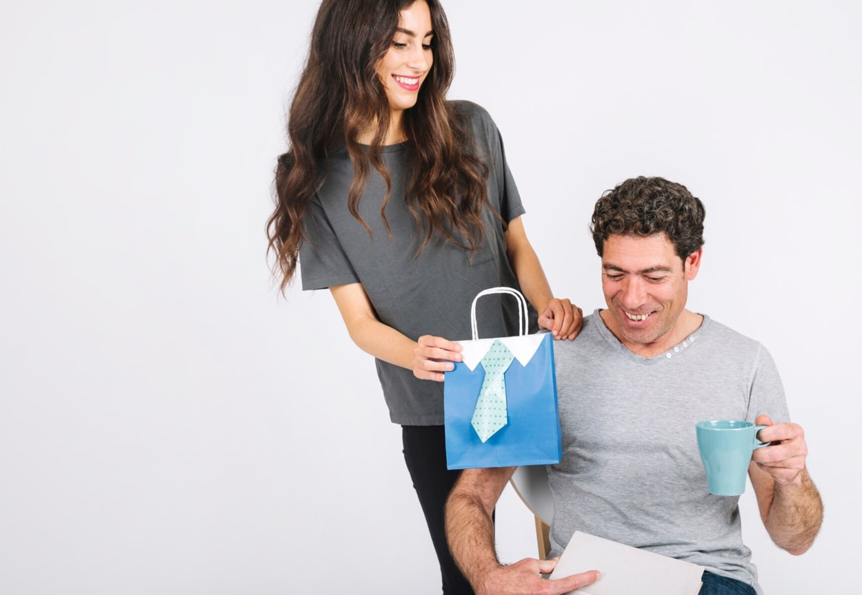 Woman giving present to cheerful dad