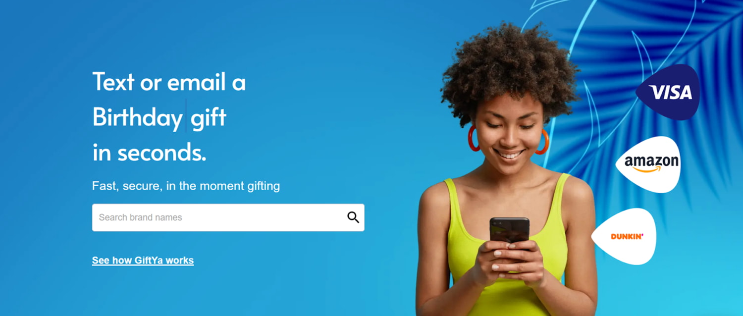 A woman texts about a birthday gift on her phone, smiling as she shares her excitement.  