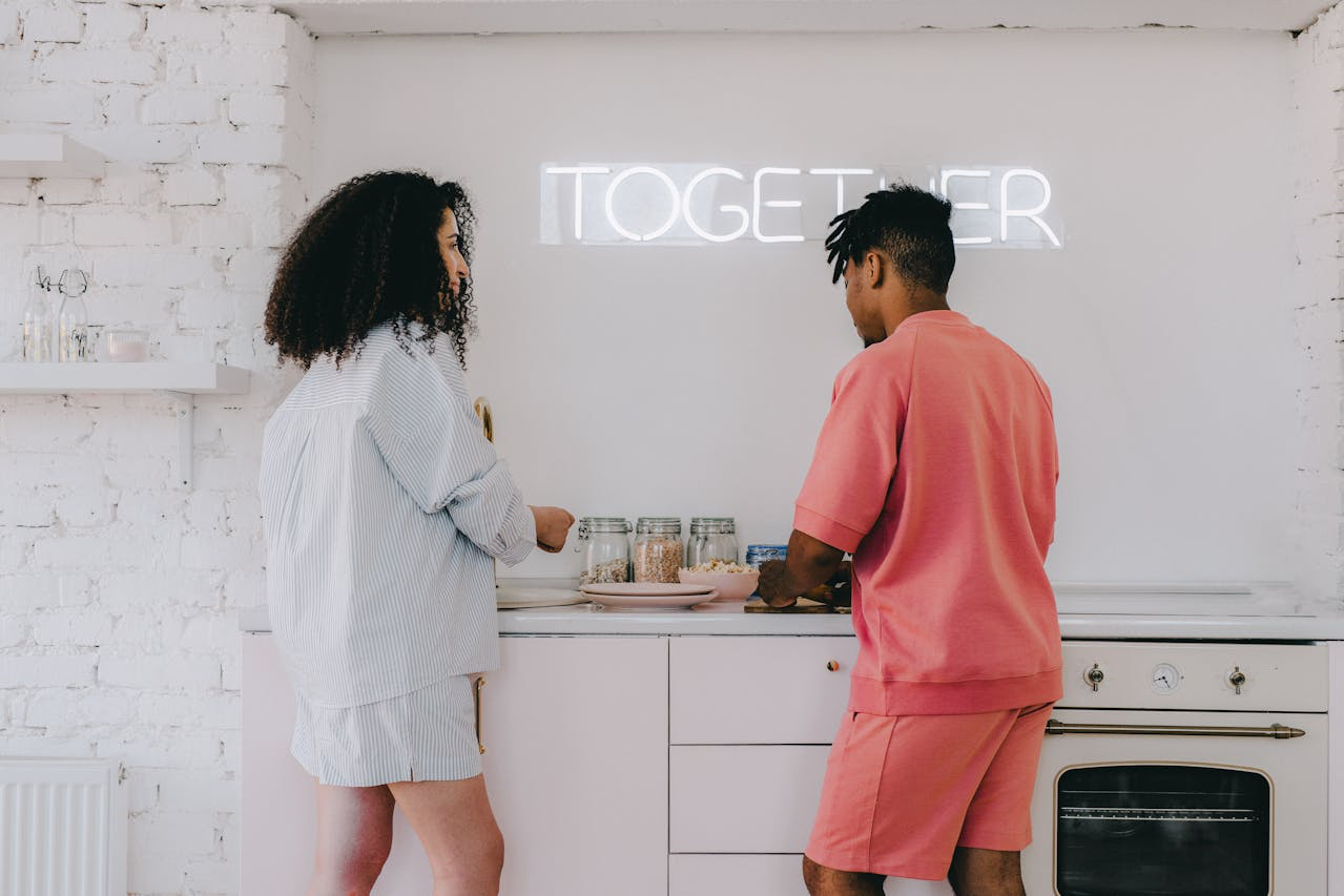 young couple cooking dinner together and smiling