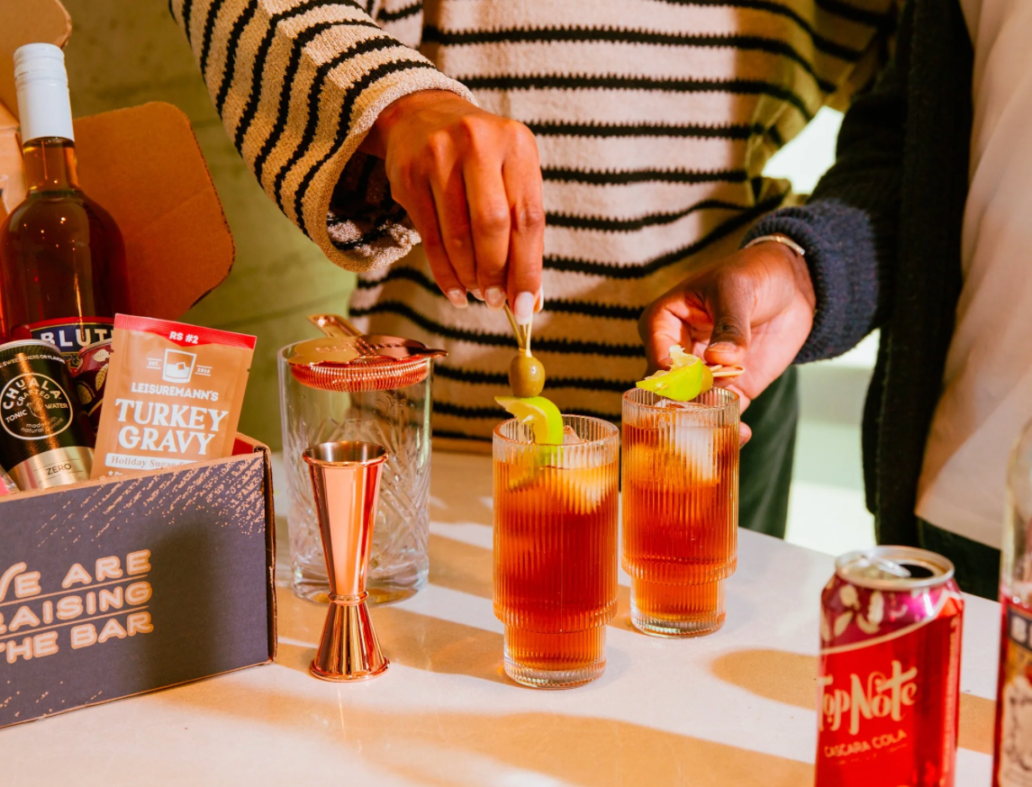 couple mixing mocktails using a fun subscription box they got as a wedding gift
