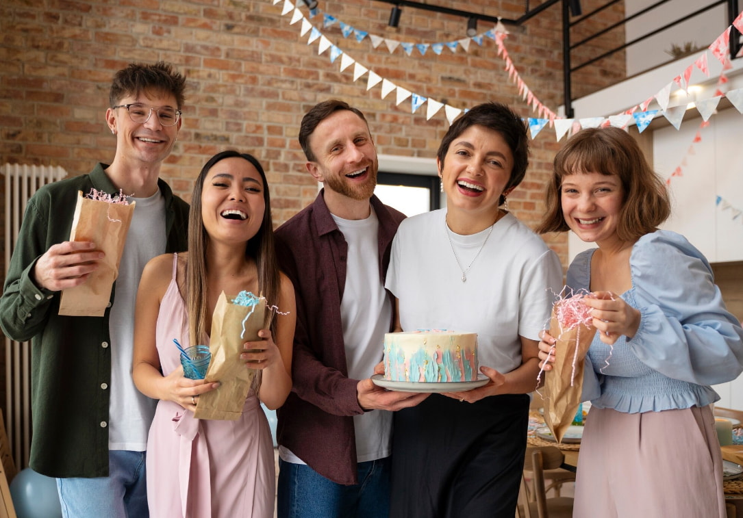 Friends happily celebrating a birthday together, surrounded by decorations, a cake, and a lively party atmosphere.  