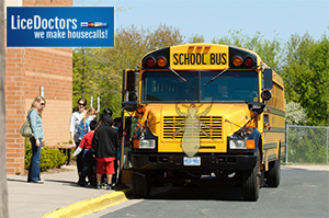 Students getting on school bus - Lice Doctors