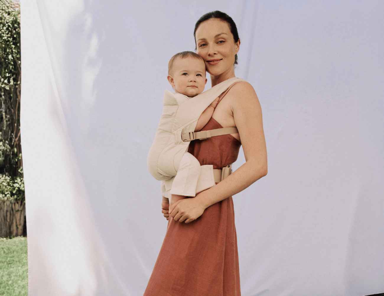 Ergobaby Omni Lite baby carrier in neutral colourway worn on a day out