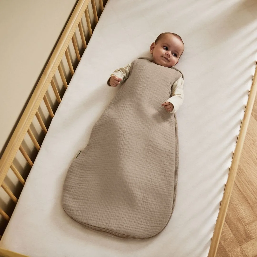 The Little Green Sheep organic muslin baby sleeping bag in a soft truffle brown