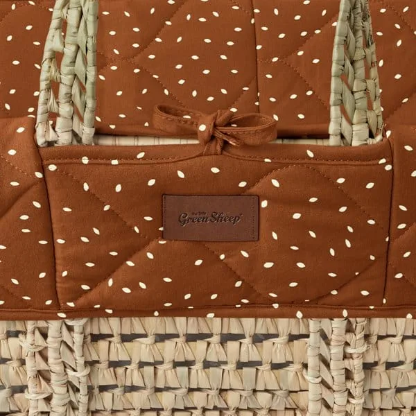 The Little Green Sheep quilted Moses basket replacement liner in terracotta with a rice print