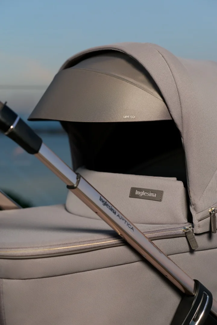 Close-up of the Inglesina Aptica carrycot hood in a soft grey fabric