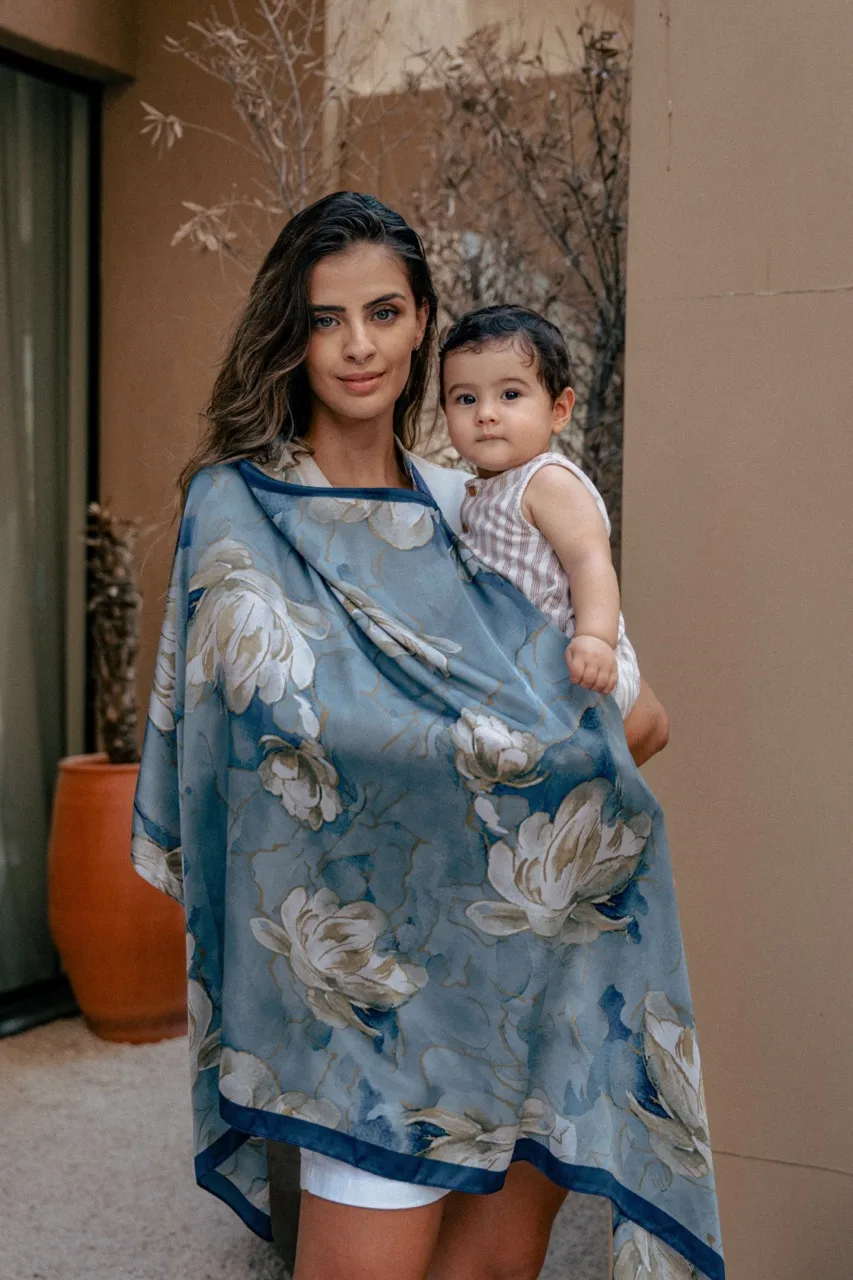 A mum holding her baby close under an AuraLai silk nursing cover