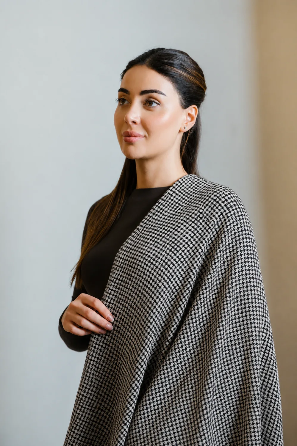 A woman wearing the AuraLai Essence Collection cover in Heritage Noir