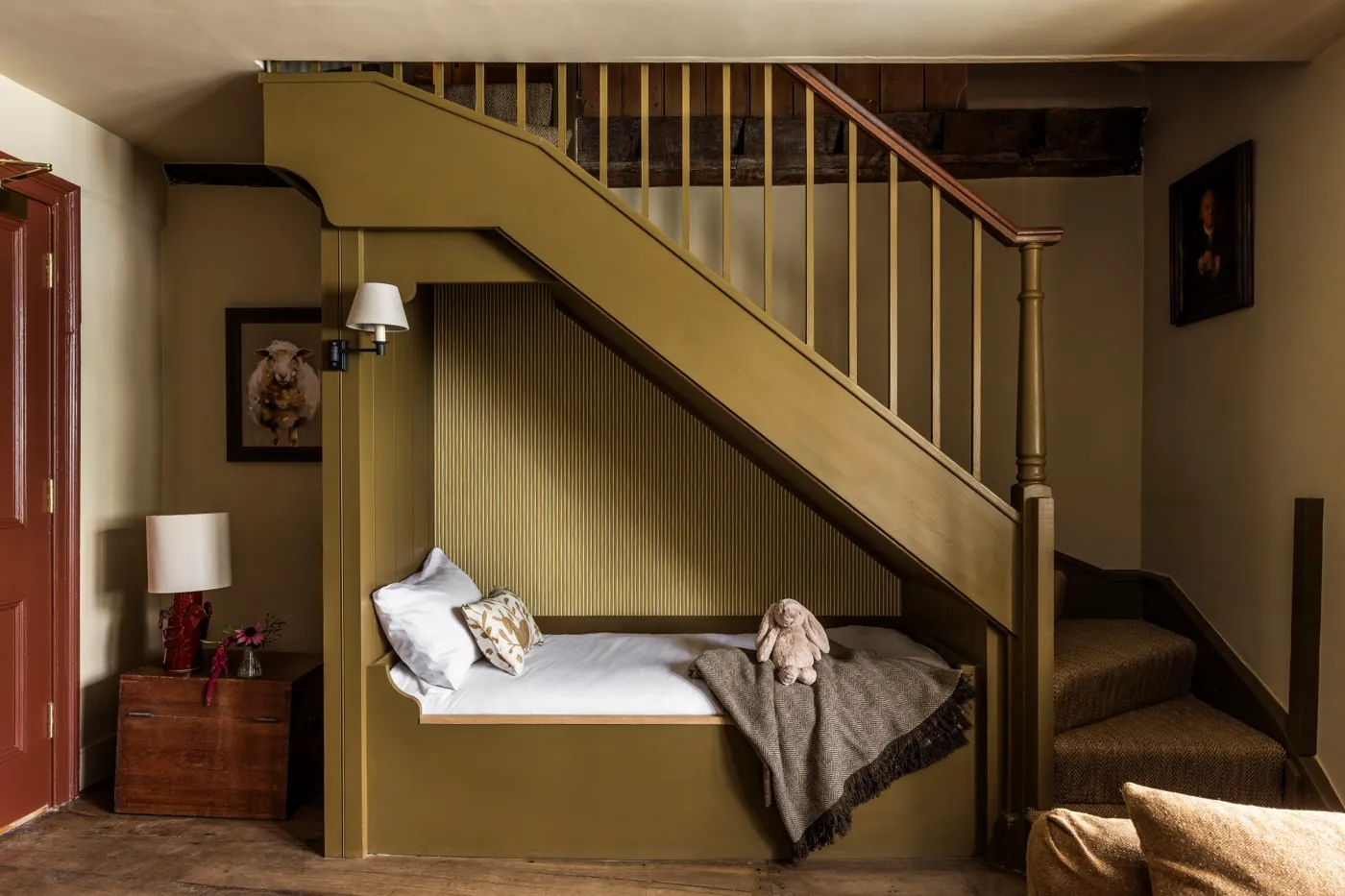 A family room under the stairs at Woolley Grange, with a cosy bed tucked into the eaves