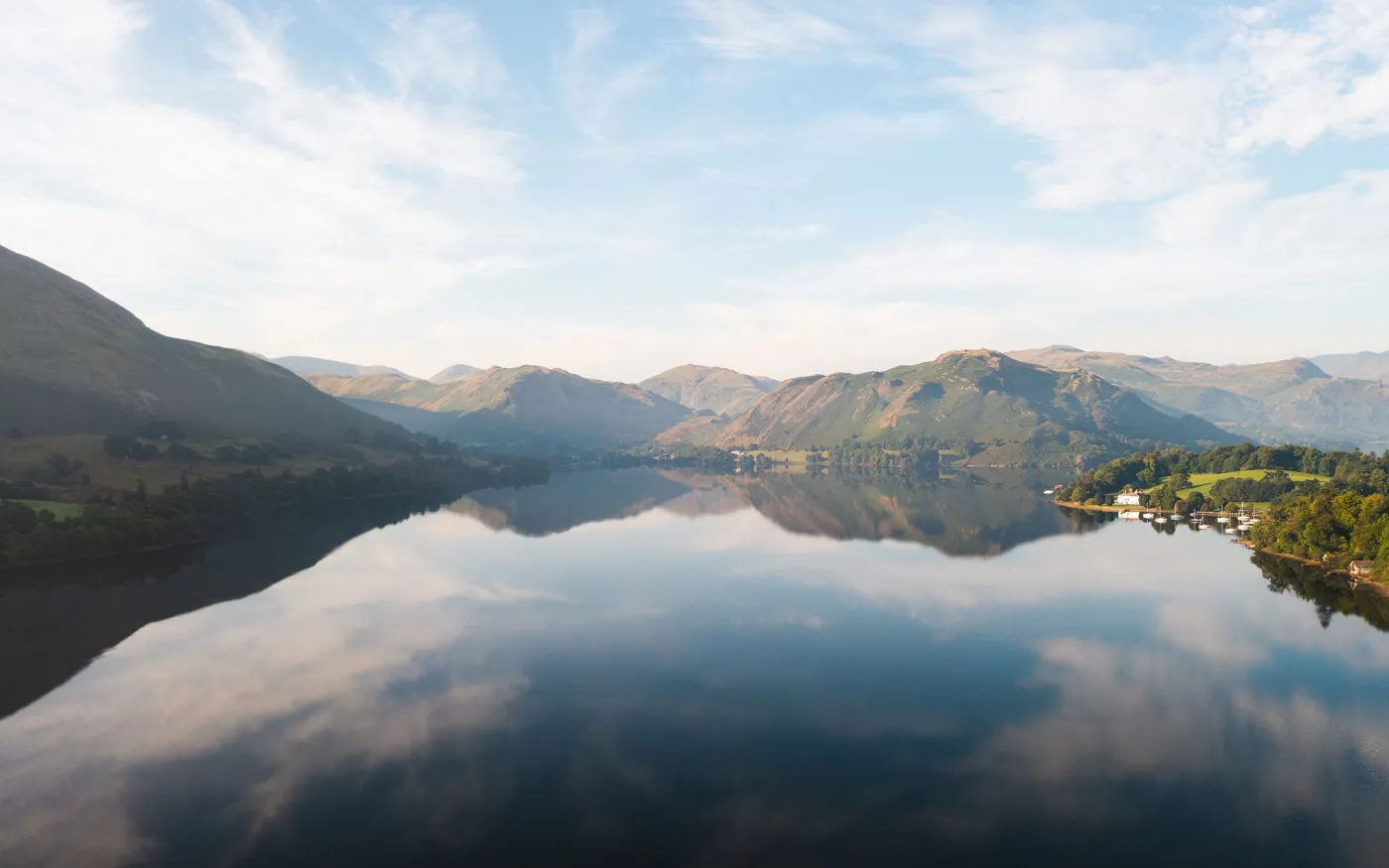 Ullswater lake reflecting the fells on a still morning