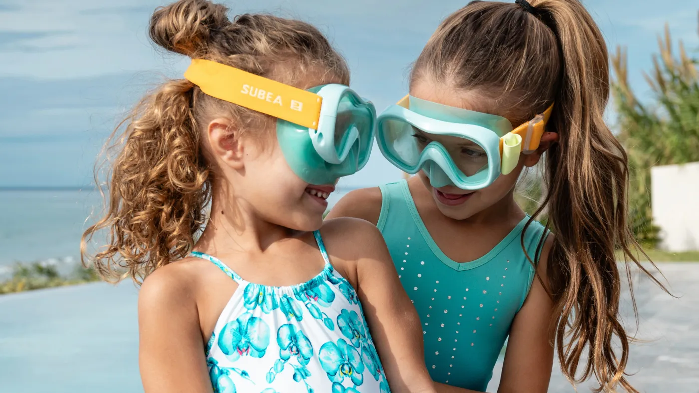 Two little girls in goggles by the pool at Grecotel LuxMe Kos Imperial