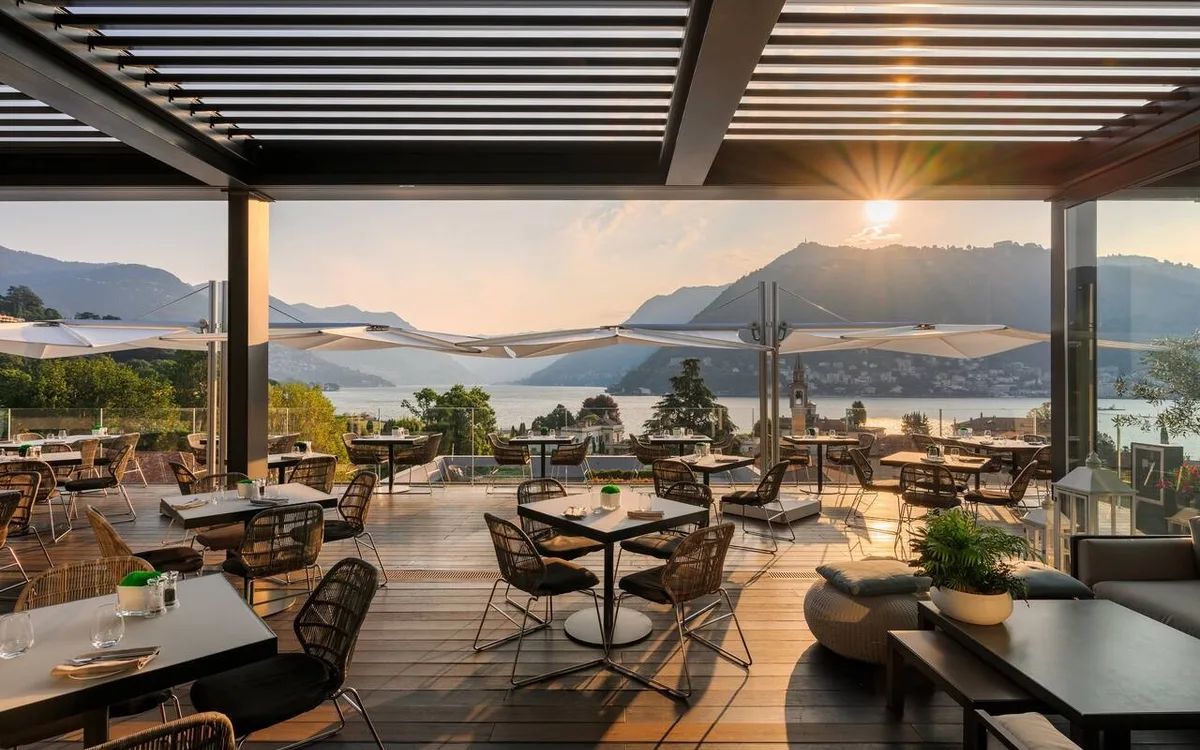 The rooftop terrace at Hilton Lake Como looking out over the lake and mountains