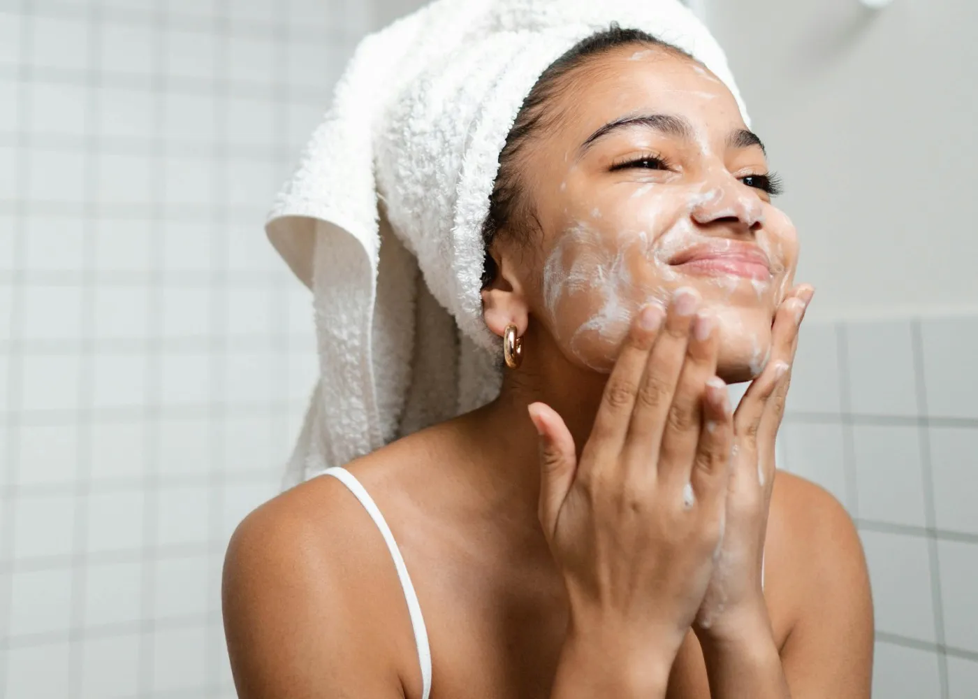 woman-washing-face-in-bathroom