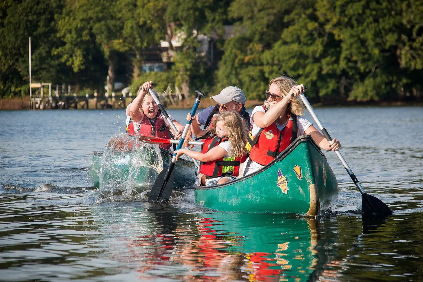A family paddling a canoe on the Beaulieu River with New Forest Activities