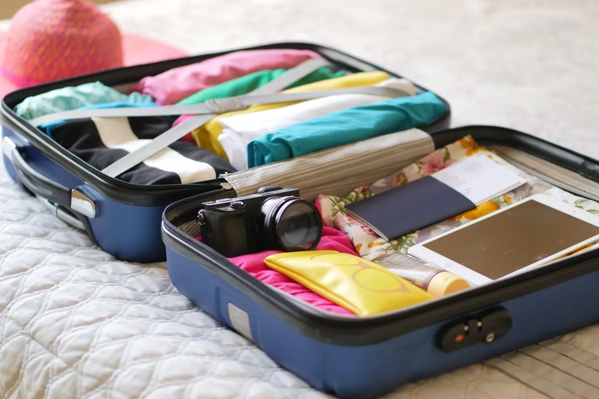 An open suitcase packed with clothes and essentials