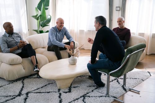 Group of men talking in an Elite Psychology Group coaching session
