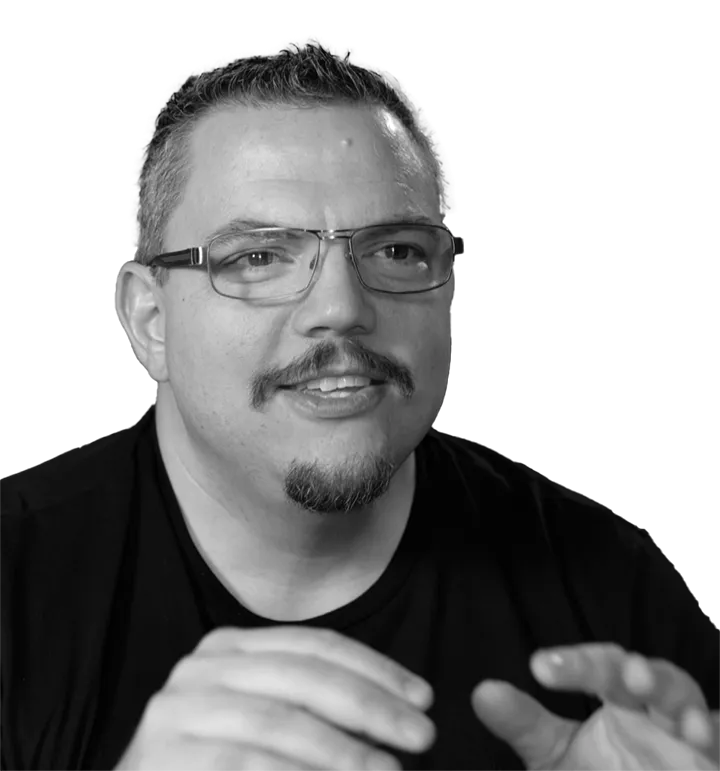 A black and white headshot of Ben Finklea. Hands visible.
