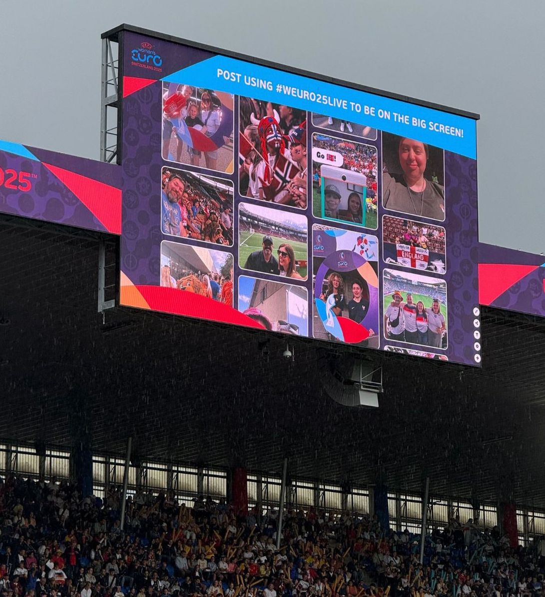 A huge signage displaying the WUEFA 2025 social wall at a stadium.