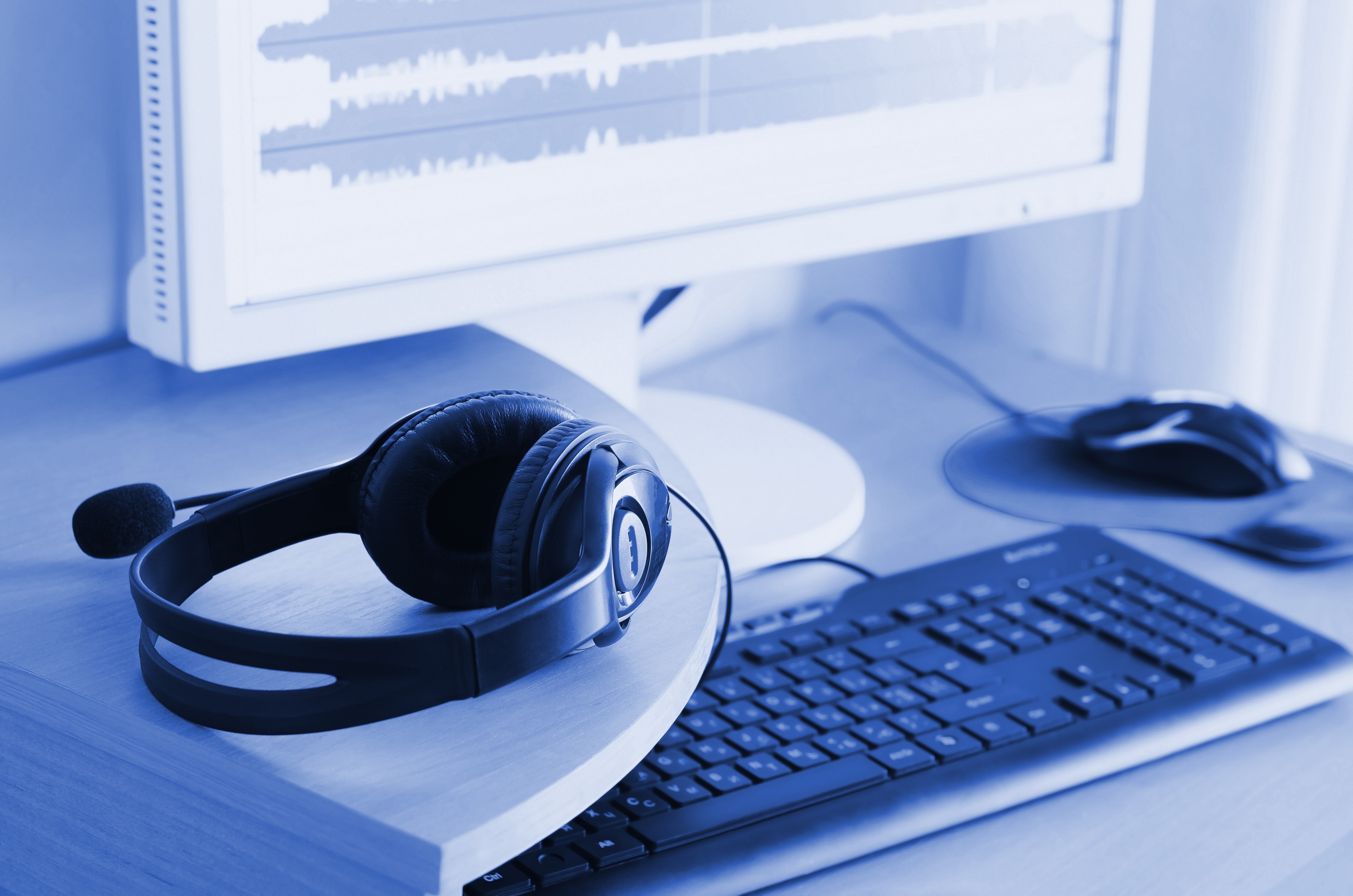 Headphones on a desk, representing customer support interfaces and CX conversations