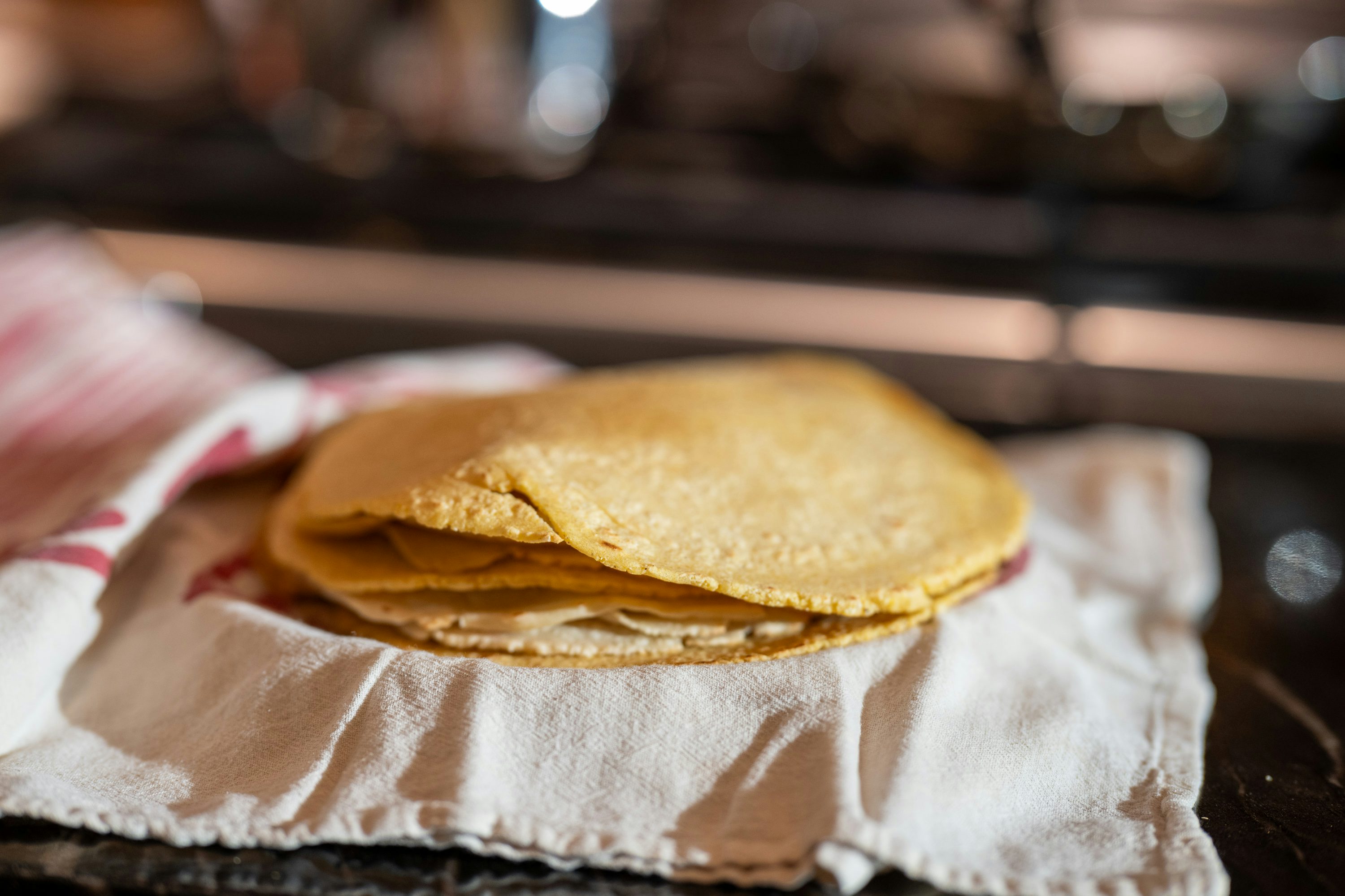 Warm corn tortillas wrapped in a cloth