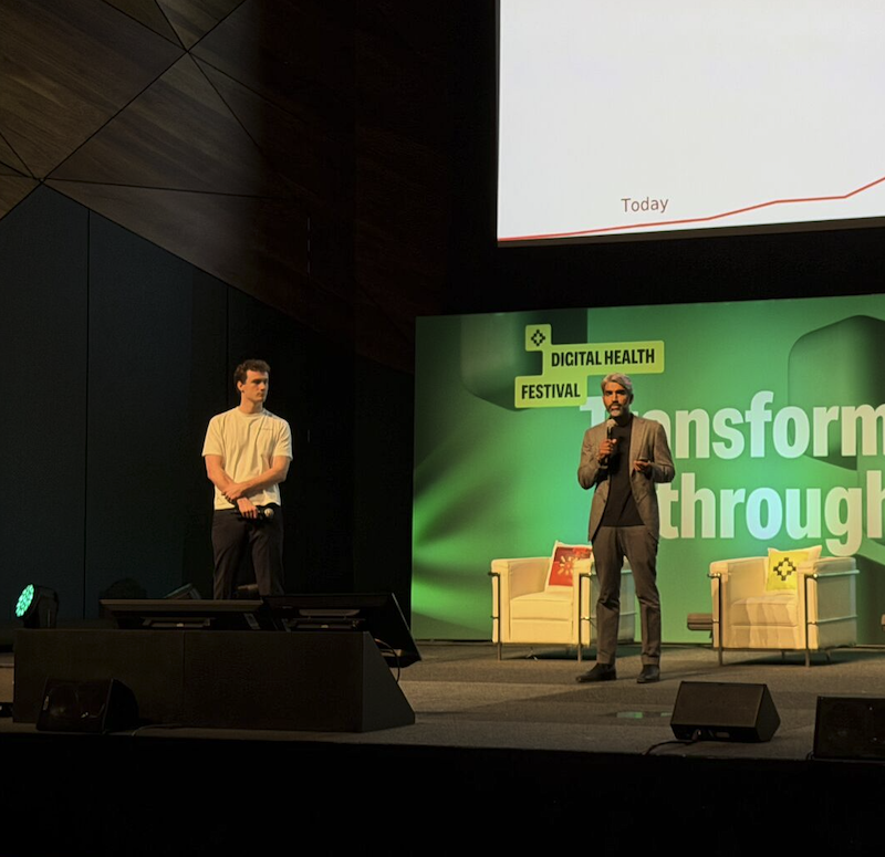 Kai van Lieshout and Dr. Ray Boyapati presenting the DHF 2026 keynote on the main stage at Australia's Digital Health Festival