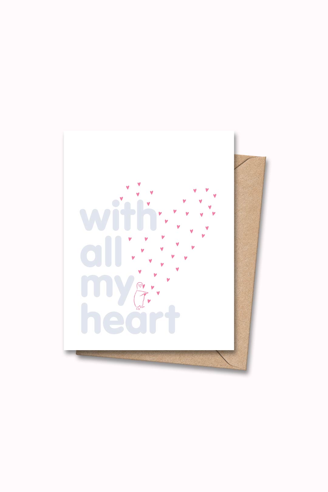 Letterpressed greeting card with pink penguin and hearts next to blue letters "with all my heart" on white card and taupe envelope