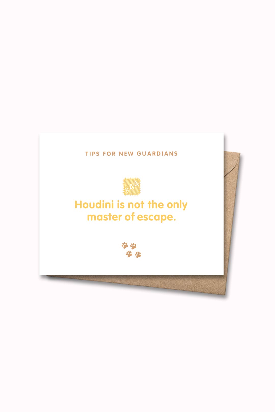 Letterpressed greeting card with wooden block and paw prints illustrations, the words "tips for new guardians: houdini is not the only master of escape." on white background, and taupe envelope
