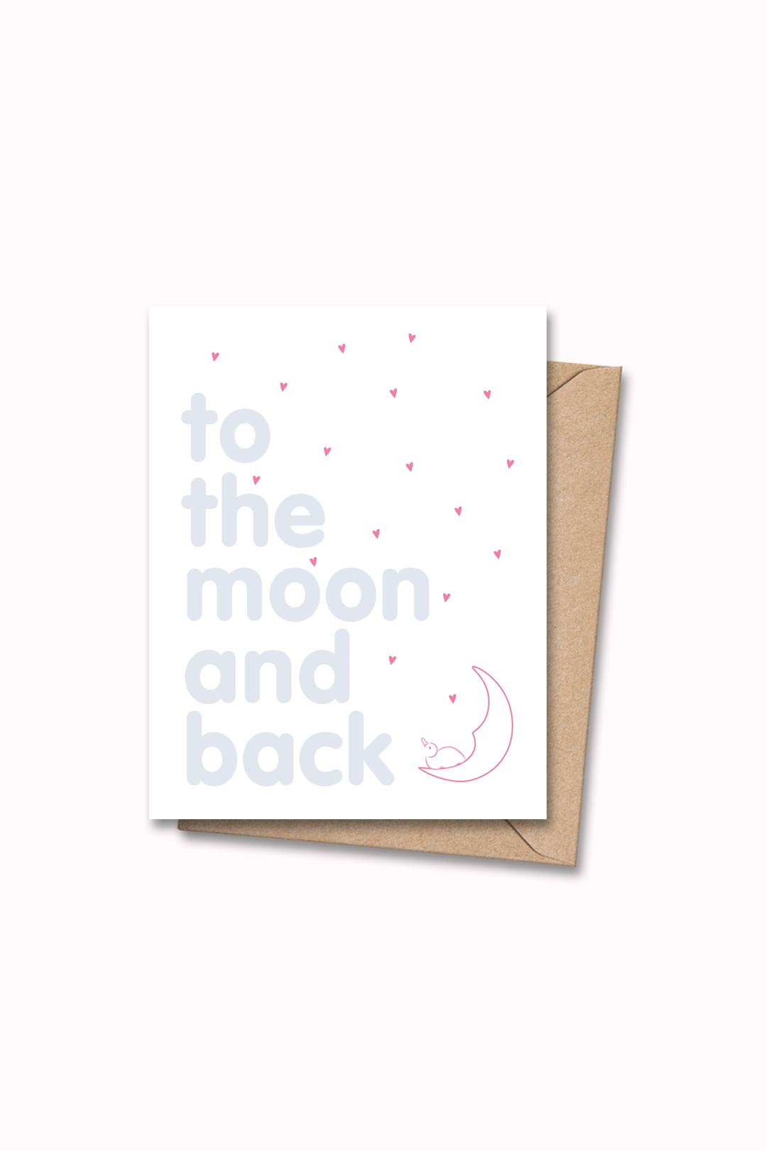 Letterpressed greeting card with pink penguin and hearts next to blue letters "to the moon and back" on white card and taupe envelope