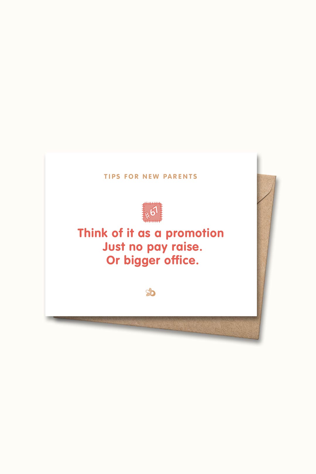 Letterpressed greeting card with wooden block and paw prints illustrations, the words "tips for new parents: think of it as a promotion. just no pay raise. or bigger office." on white background, and taupe envelope