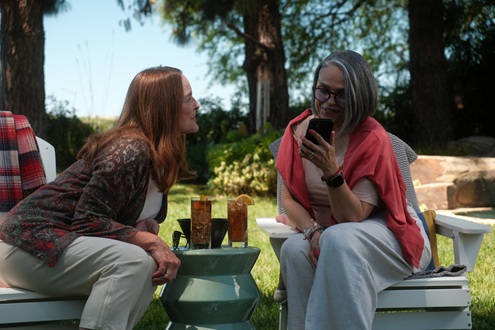 Two people sitting outside talking