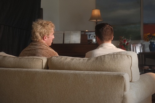 Two people sitting on a couch