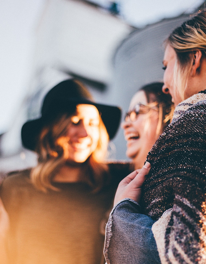 A group of women laughing together showing how happy they are using Kinnect