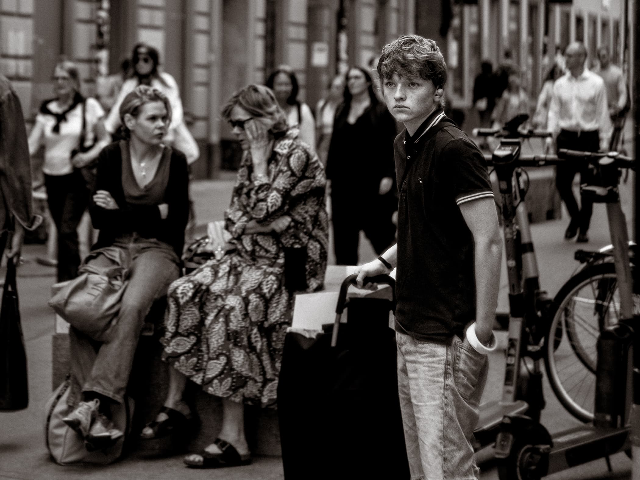 Portrait of street promoter starring into the distance in a busy street