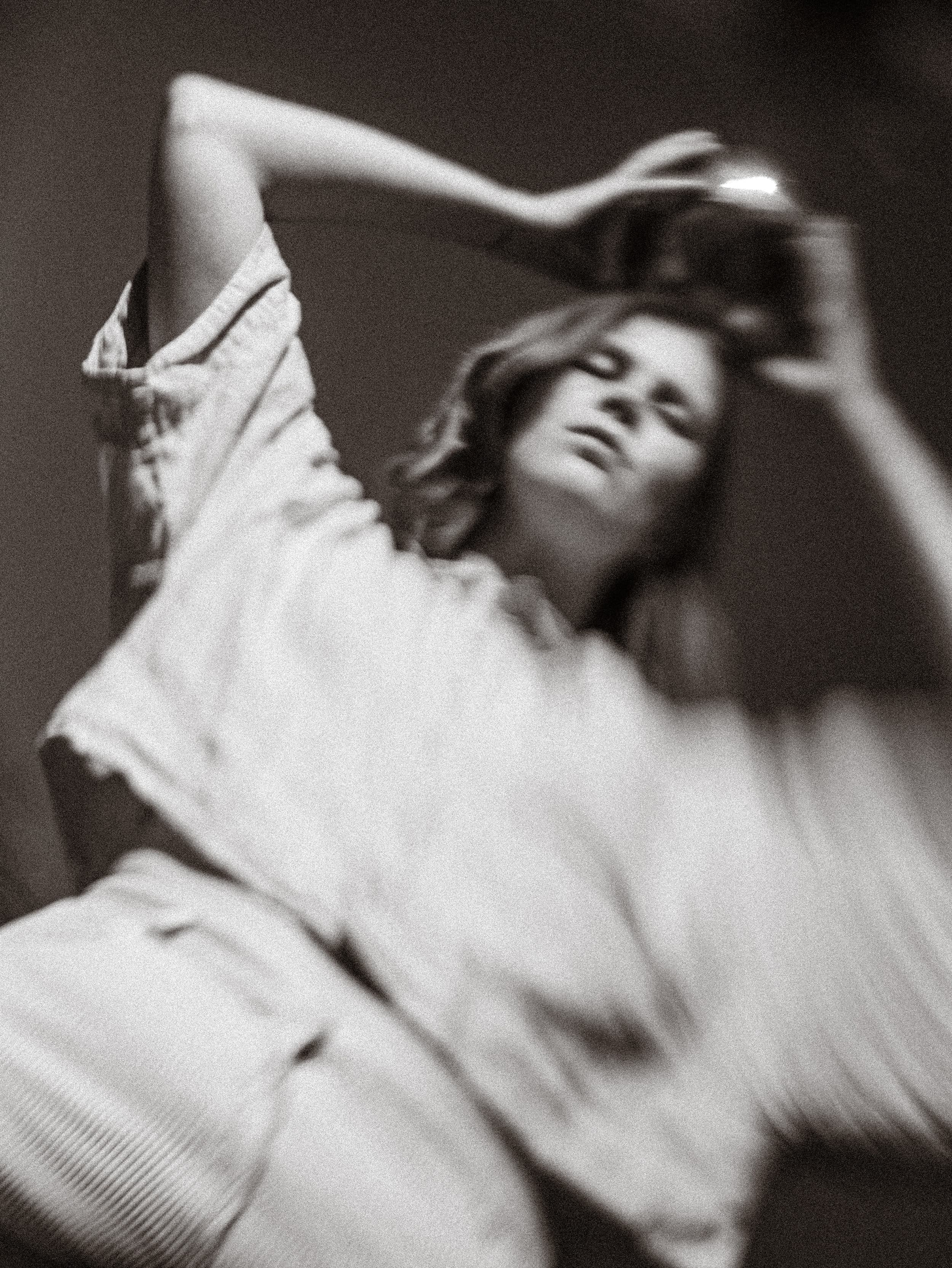 Distorted image of a woman holding a mirror ball over her head