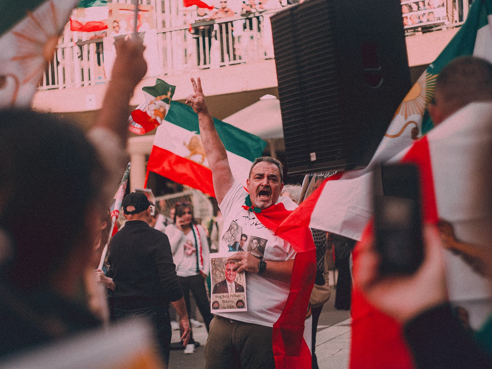 Man shouting with his hand up in the air at a protest